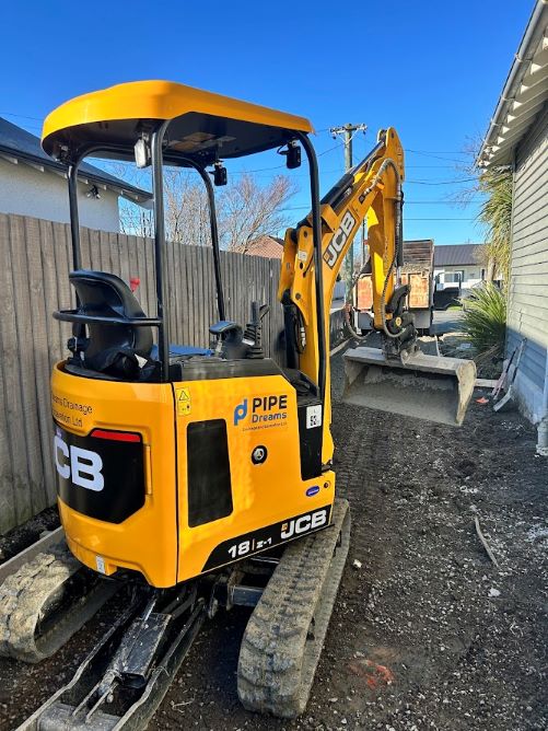 Pipe Dreams mini digger on site grading and excavation work